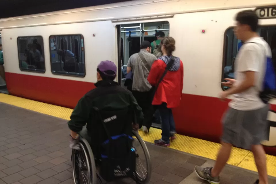 Person in a wheelchair entering an inbound Red Line train at Harvard Square